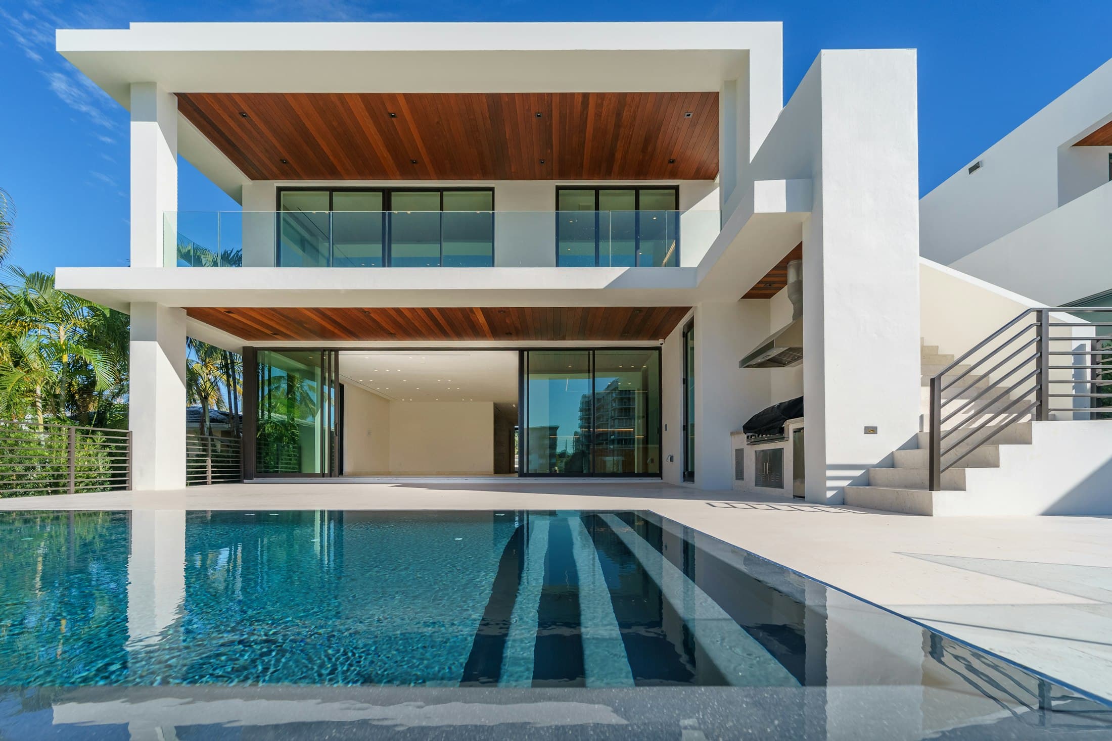 A modern home with a pool at golden hour